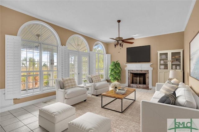 105 Crooked Wood Ln, Savannah, GA 31406 - living room featuring a ceiling fan, a premium fireplace, ornamental molding, and light tile patterned floors