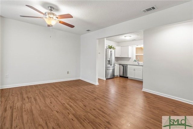 108 Gilliam Ave, Savannah, GA 31406 - unfurnished living room with a ceiling fan, wood finished floors, and baseboards