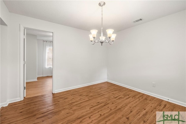108 Gilliam Ave, Savannah, GA 31406 - spare room featuring a chandelier, wood finished floors, and baseboards
