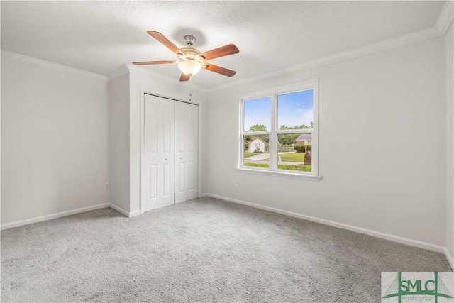 108 Gilliam Ave, Savannah, GA 31406 - unfurnished bedroom with crown molding, carpet flooring, a closet, baseboards, and a textured ceiling