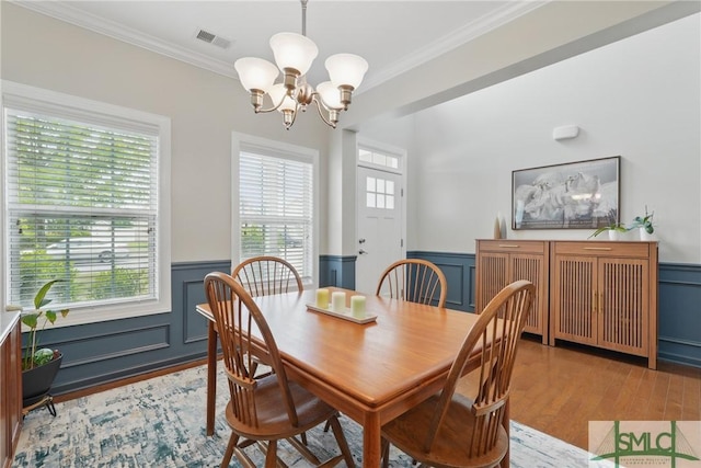 17 Olde Gate Ct, Pooler, GA 31322 - dining area with a chandelier, a wainscoted wall, crown molding, wood finished floors, and a decorative wall