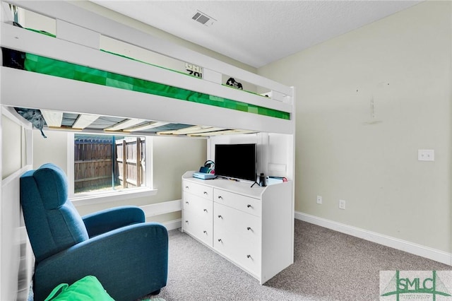 living area with light colored carpet and baseboards