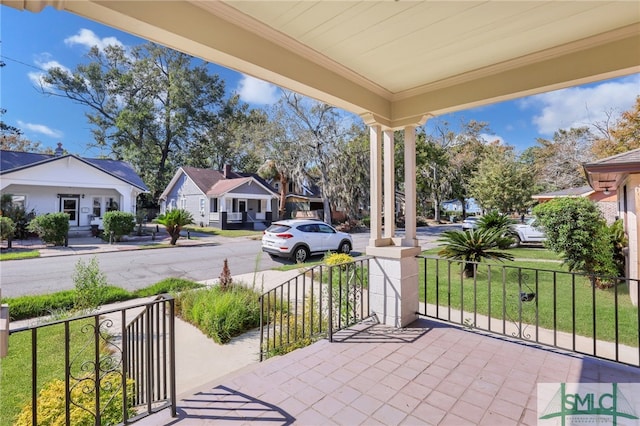 view of patio / terrace featuring a porch and a residential view