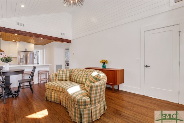 living room featuring stacked washer and clothes dryer, wood finished floors, wooden ceiling, and high vaulted ceiling