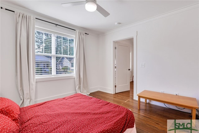 bedroom with wood finished floors, baseboards, ornamental molding, and ceiling fan