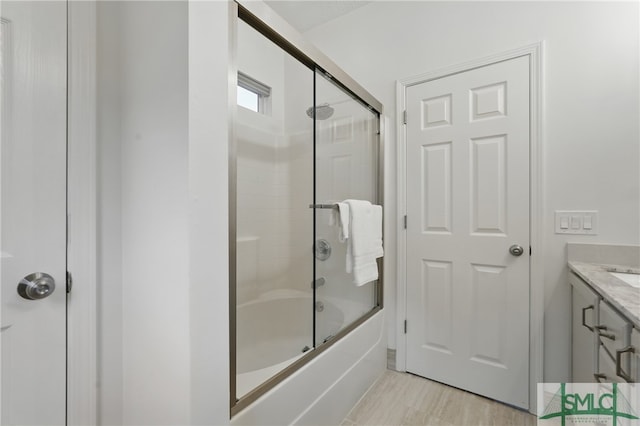 full bathroom featuring bath / shower combo with glass door and vanity