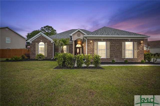 view of front of property featuring brick siding and roof with shingles
