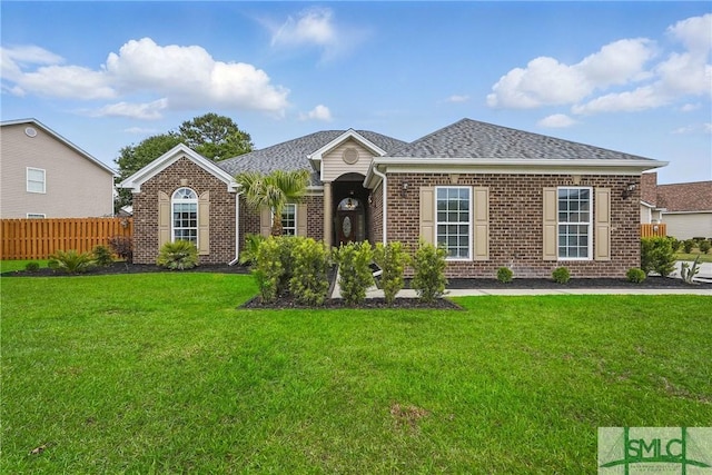 view of front of home with brick siding and roof with shingles