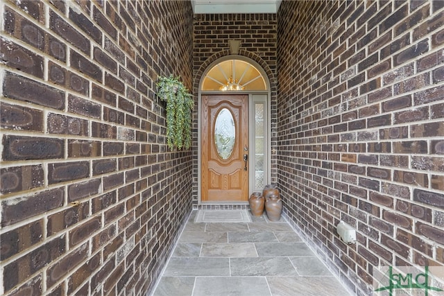 property entrance with brick siding