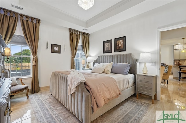 bedroom with multiple windows, crown molding, a chandelier, and a raised ceiling