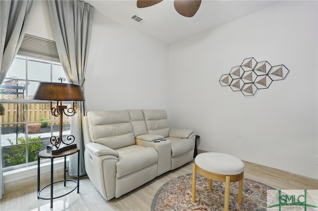 living room featuring ceiling fan and light wood finished floors