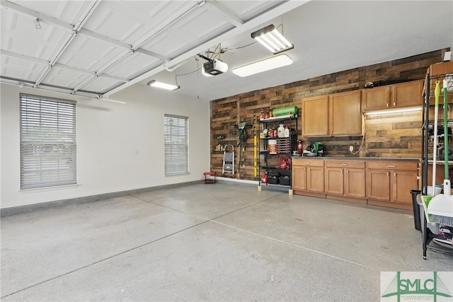 garage with a garage door opener and baseboards