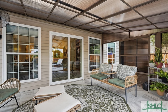 sunroom with healthy amount of natural light and coffered ceiling