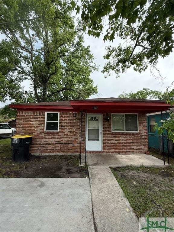 single story home with brick siding and fence