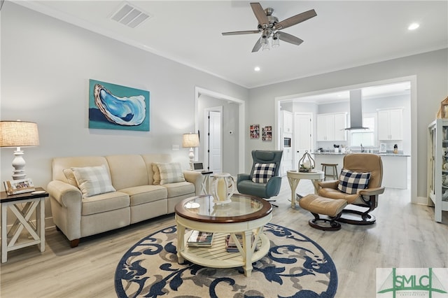 240 Blackjack Oak Dr W, Richmond Hill, GA 31324 - living room featuring light wood-style flooring, a ceiling fan, ornamental molding, and recessed lighting