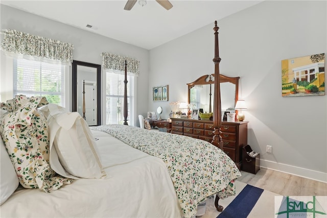 240 Blackjack Oak Dr W, Richmond Hill, GA 31324 - bedroom with wood finished floors, multiple windows, baseboards, and a ceiling fan