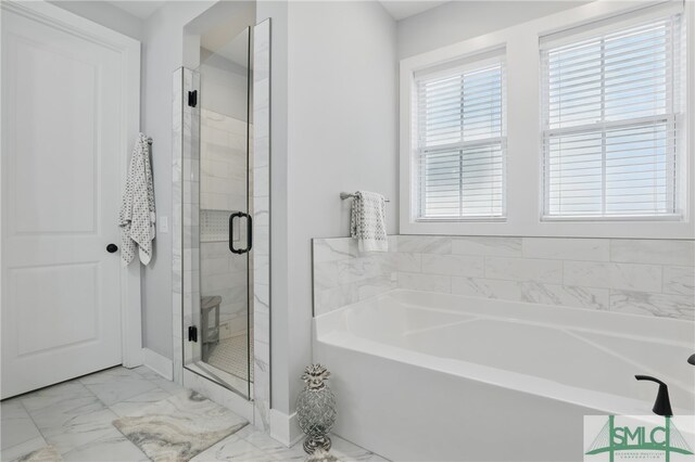 240 Blackjack Oak Dr W, Richmond Hill, GA 31324 - bathroom with a bath, marble look tiles, a stall shower, and baseboards