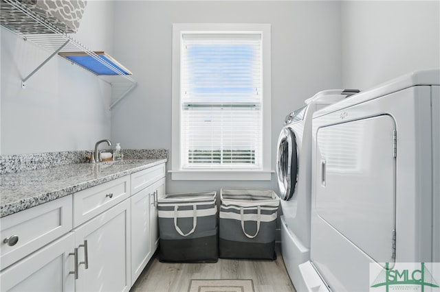 240 Blackjack Oak Dr W, Richmond Hill, GA 31324 - laundry room with independent washer and dryer, cabinet space, and light wood-style flooring