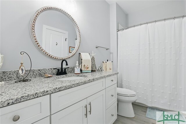 240 Blackjack Oak Dr W, Richmond Hill, GA 31324 - full bath with wood finished floors, vanity, toilet, and curtained shower