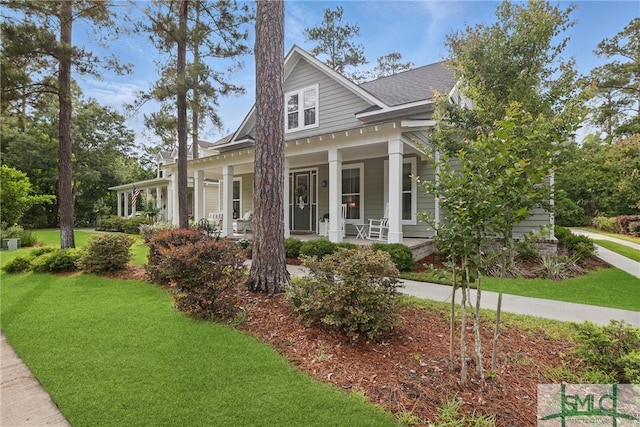 240 Blackjack Oak Dr W, Richmond Hill, GA 31324 - view of front of home with covered porch and a front lawn