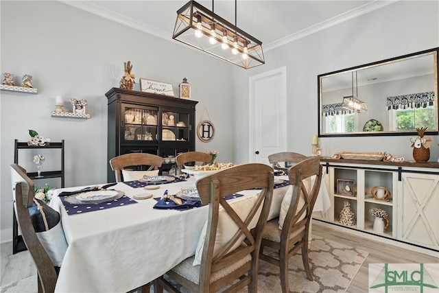 240 Blackjack Oak Dr W, Richmond Hill, GA 31324 - dining space with ornamental molding, a chandelier, and light wood finished floors
