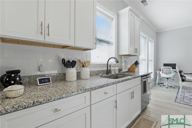 240 Blackjack Oak Dr W, Richmond Hill, GA 31324 - kitchen featuring a sink, stainless steel dishwasher, white cabinets, backsplash, and light stone countertops