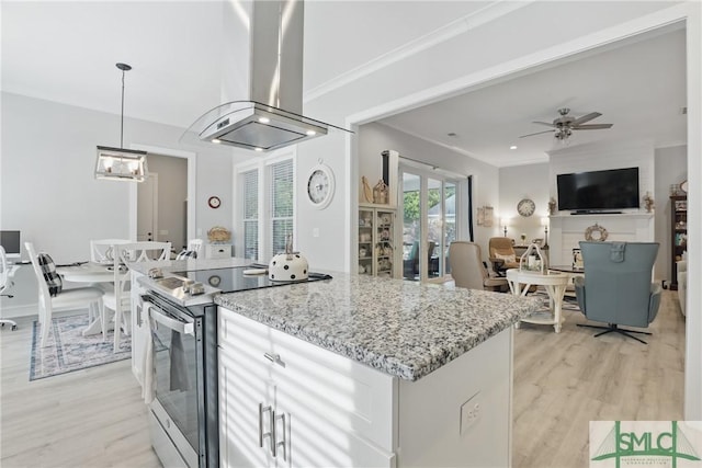 240 Blackjack Oak Dr W, Richmond Hill, GA 31324 - kitchen with electric range, island exhaust hood, light wood-style floors, light stone counters, and pendant lighting
