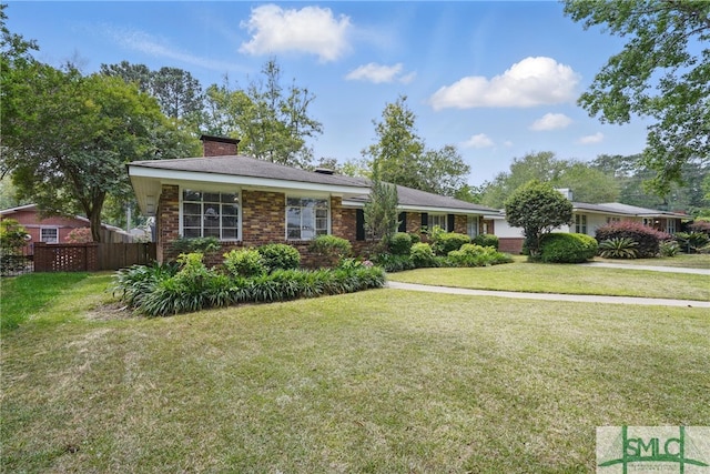 view of front of property with a chimney and brick siding