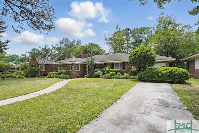 single story home with brick siding, a front lawn, and a chimney