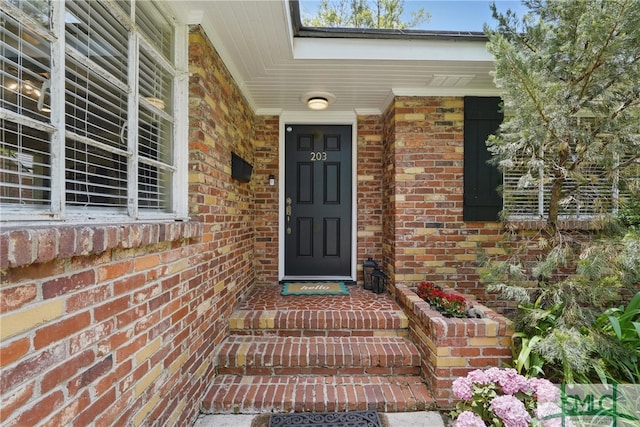 property entrance with brick siding