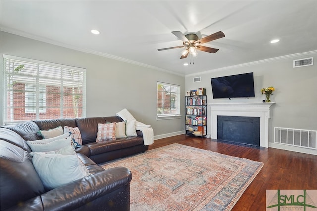 living area with a ceiling fan, baseboards, crown molding, recessed lighting, and wood finished floors