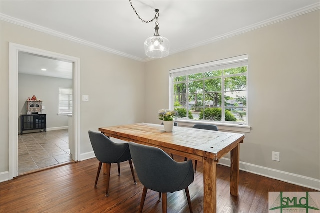dining space with healthy amount of natural light, baseboards, wood finished floors, and ornamental molding