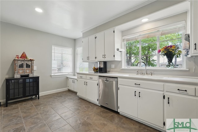 kitchen featuring dishwasher, baseboards, plenty of natural light, a sink, and recessed lighting