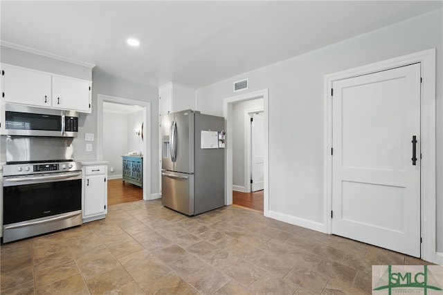 kitchen featuring appliances with stainless steel finishes, white cabinets, light countertops, baseboards, and recessed lighting