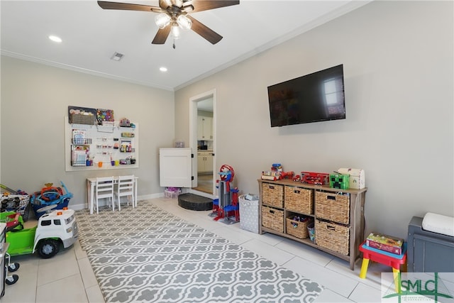 playroom with tile patterned floors, a ceiling fan, ornamental molding, recessed lighting, and baseboards