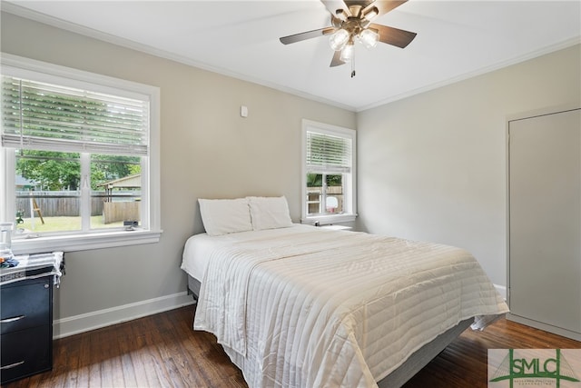 bedroom featuring baseboards, dark wood-style floors, ornamental molding, and ceiling fan