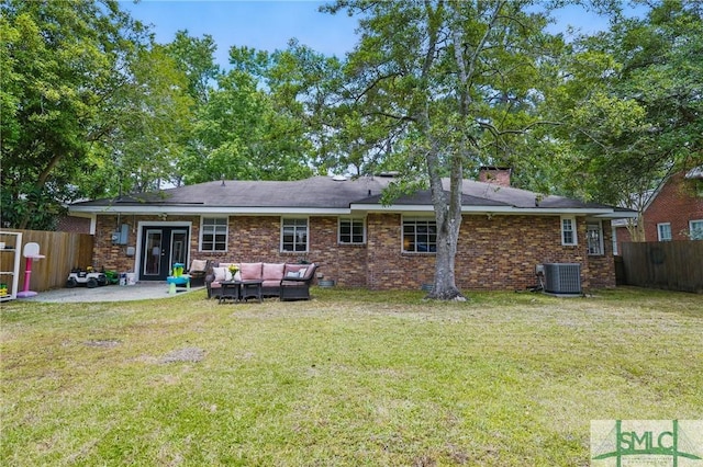 back of house with central AC unit, an outdoor hangout area, a patio area, a chimney, and french doors