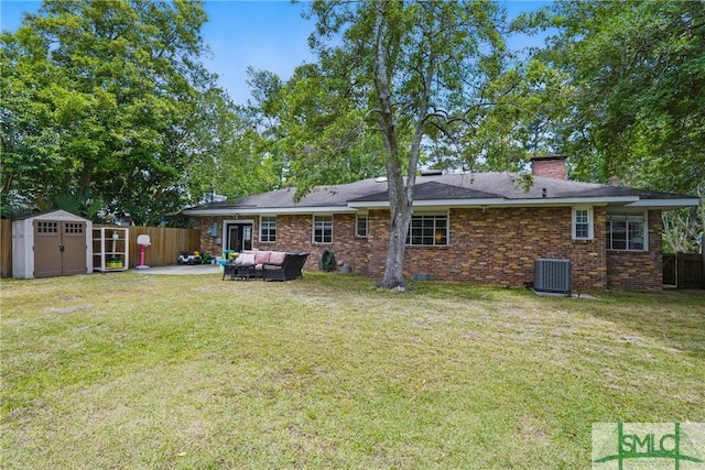 rear view of house with a shed, an outdoor living space, central AC unit, an outbuilding, and a patio