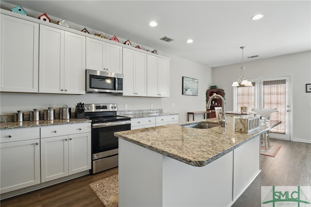 kitchen with appliances with stainless steel finishes, a sink, dark wood-type flooring, white cabinetry, and recessed lighting