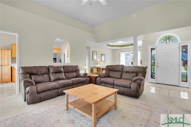 113 Taylor Ct, Richmond Hill, GA 31324 - living area featuring ceiling fan, light tile patterned floors, light carpet, ornate columns, and arched walkways
