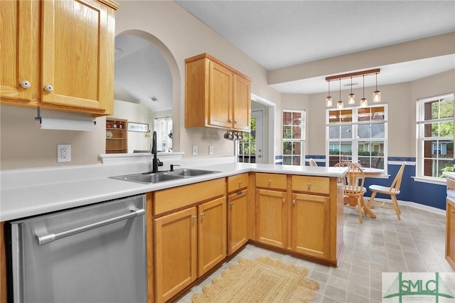 113 Taylor Ct, Richmond Hill, GA 31324 - kitchen with stainless steel dishwasher, a sink, a peninsula, light countertops, and decorative light fixtures