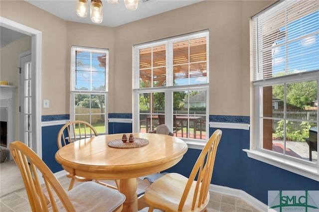 113 Taylor Ct, Richmond Hill, GA 31324 - dining space featuring healthy amount of natural light, a chandelier, baseboards, and a fireplace