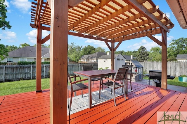 113 Taylor Ct, Richmond Hill, GA 31324 - wooden deck featuring a storage shed, outdoor dining area, a pergola, an outbuilding, and a residential view