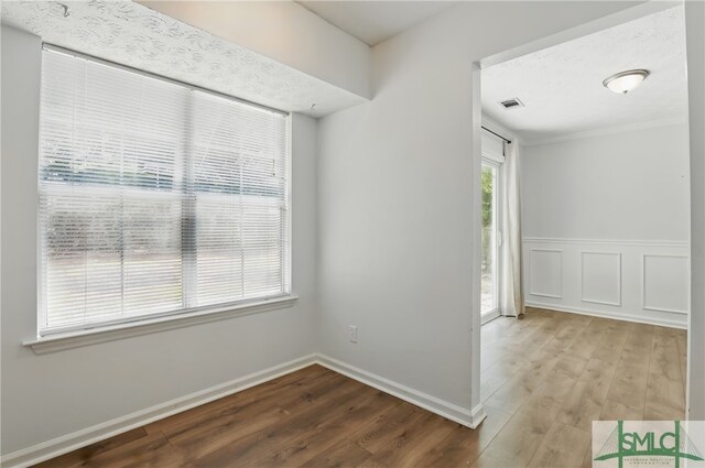 57 Cut Off Way, Richmond Hill, GA 31324 - unfurnished room with wood finished floors, baseboards, and crown molding