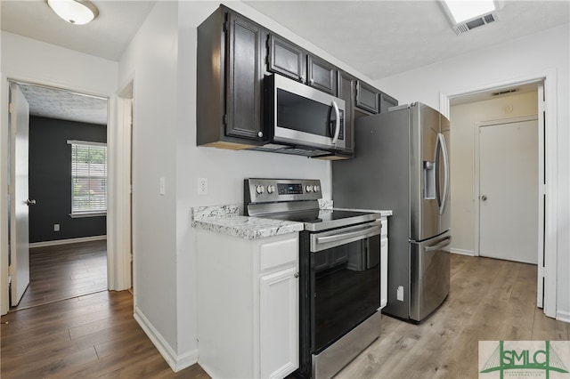 57 Cut Off Way, Richmond Hill, GA 31324 - kitchen featuring stainless steel appliances, light wood finished floors, and baseboards