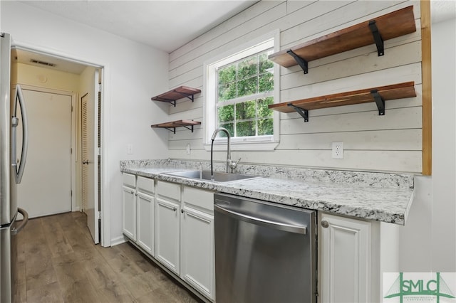 57 Cut Off Way, Richmond Hill, GA 31324 - kitchen with open shelves, appliances with stainless steel finishes, a sink, white cabinets, and wood finished floors