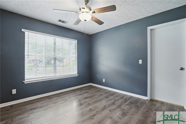 57 Cut Off Way, Richmond Hill, GA 31324 - empty room featuring a ceiling fan, a textured ceiling, wood finished floors, and baseboards