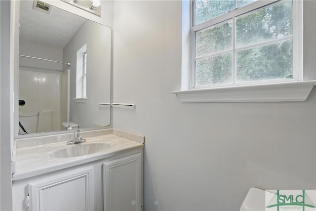 57 Cut Off Way, Richmond Hill, GA 31324 - full bath with toilet, a shower, vanity, and healthy amount of natural light