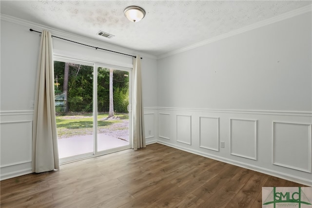 57 Cut Off Way, Richmond Hill, GA 31324 - spare room with wood finished floors, a textured ceiling, crown molding, a wainscoted wall, and a decorative wall