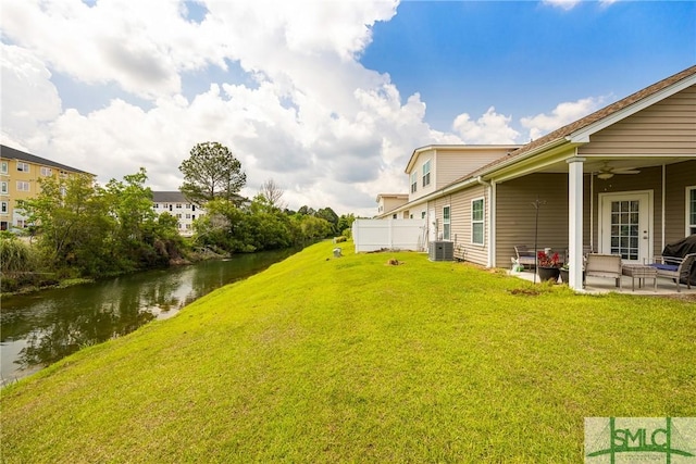 38 Travertine Cir, Savannah, GA 31419 - view of grassy yard with ceiling fan, a patio, central air condition unit, and a water view